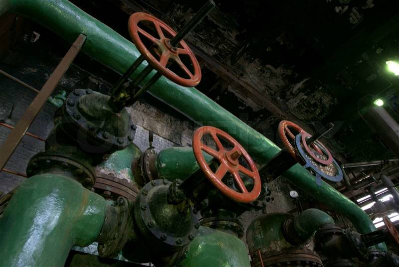 Pipes, tubes, machinery and steam turbine at a power plant , stock photo