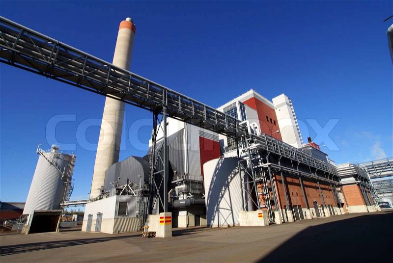 Modern industrial factory against blue sky, stock photo
