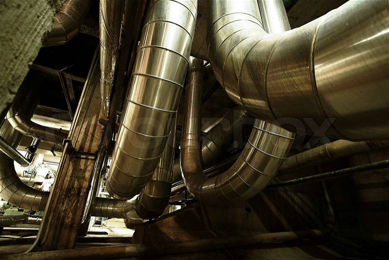 Equipment, cables and piping as found inside of a modern industrial power plant , stock photo