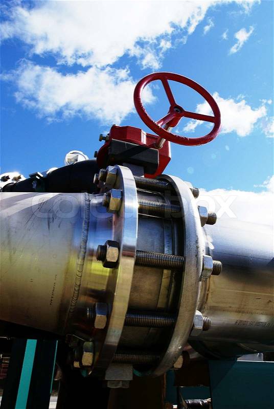 Industrial zone, Steel pipelines and valves against blue sky , stock photo