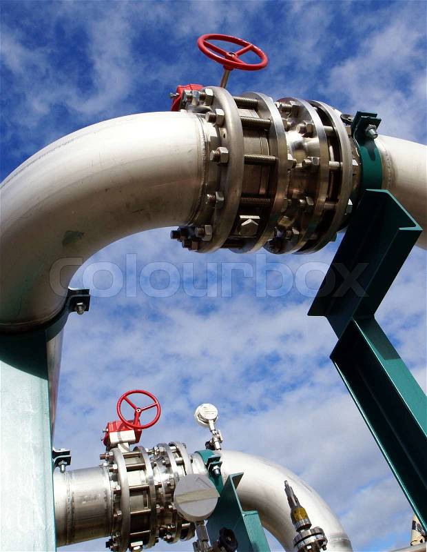 Industrial zone, Steel pipelines and valves against blue sky , stock photo