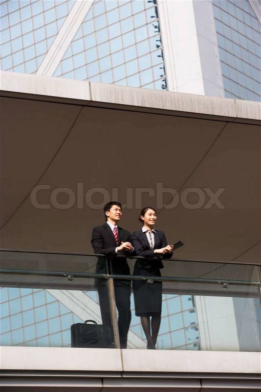 Two Business Colleagues Having Discussion Outside Office Building, stock photo