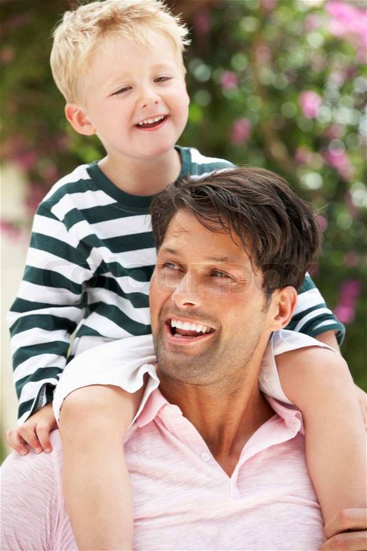 Father Giving Son Ride On Shoulders Outdoors, stock photo