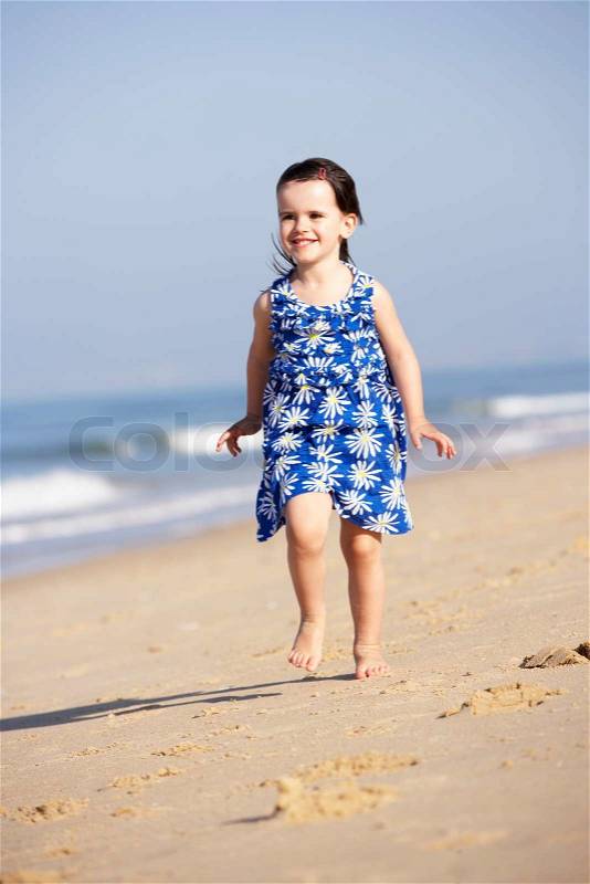 Little Girl Running Along Beach, stock photo