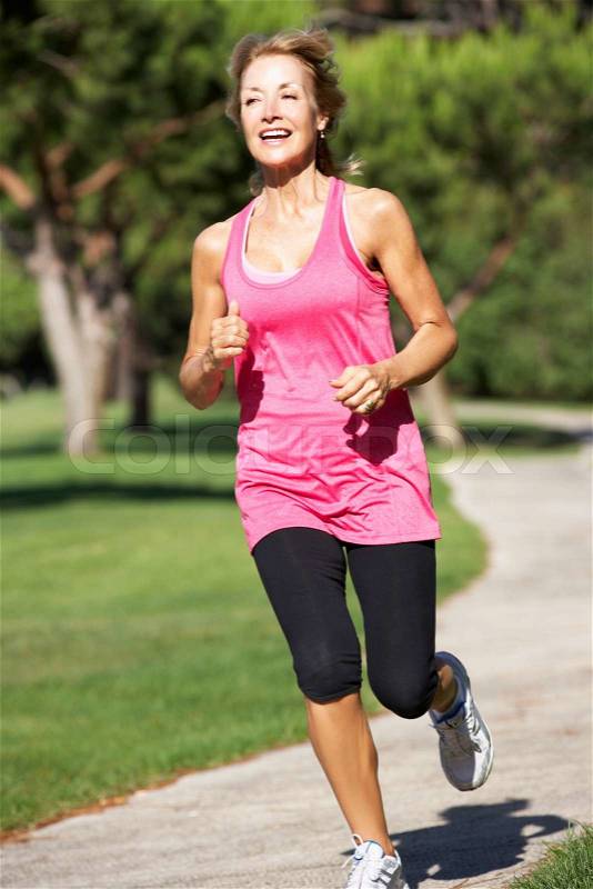 Senior Woman Exercising In Park, stock photo