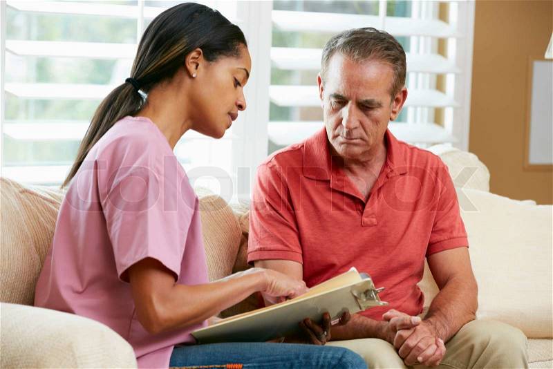 Nurse Discussing Records With Senior Male Patient During Home Visit, stock photo