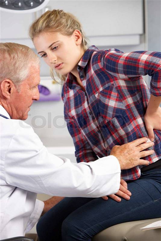 Teenage Girl Visits Doctor\'s Office With Back Pain, stock photo