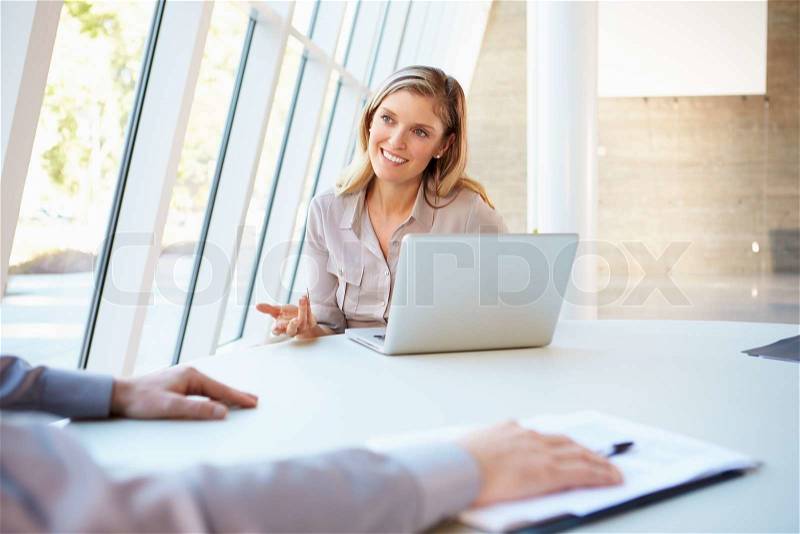 Business people Having Meeting Around Table In Modern Office, stock photo