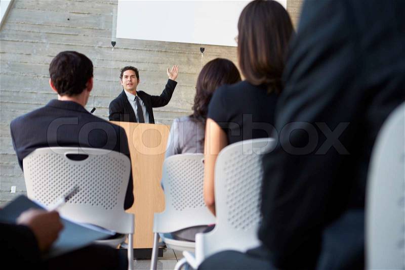 Businessman Delivering Presentation At Conference, stock photo