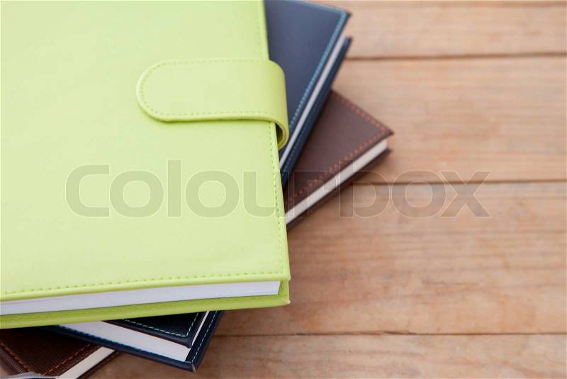 Notebook stack on wood table, stock photo