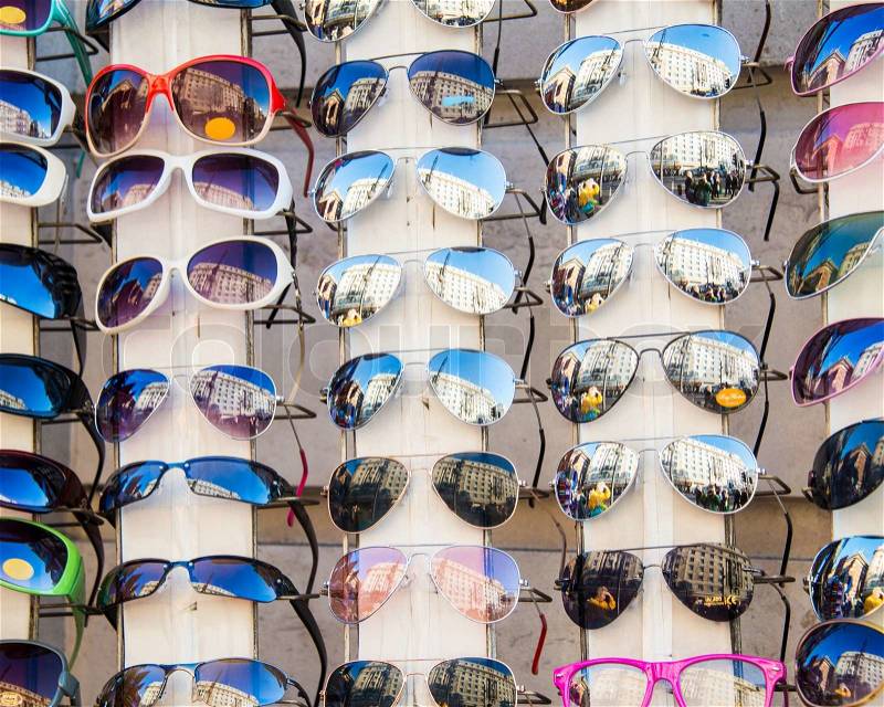Many sunglasses on display in shop, stock photo