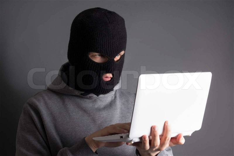 Hacker stealing data from notebook over grey, stock photo