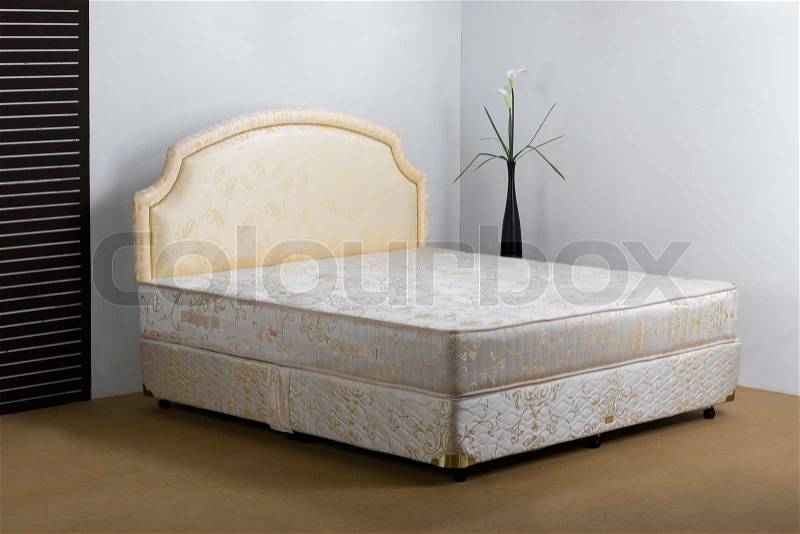 Bedding mattress in a set up bedroom atmosphere, stock photo
