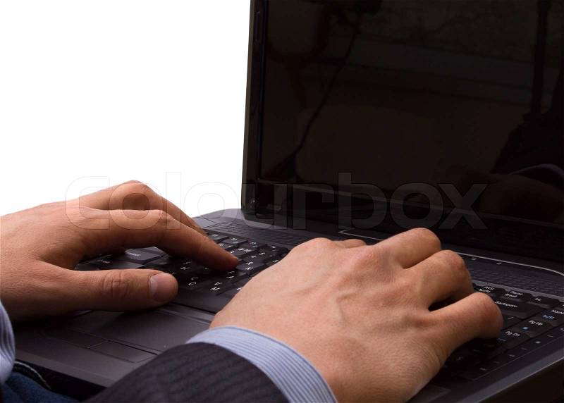 Businessman holding a laptop on his knees working on it, stock photo