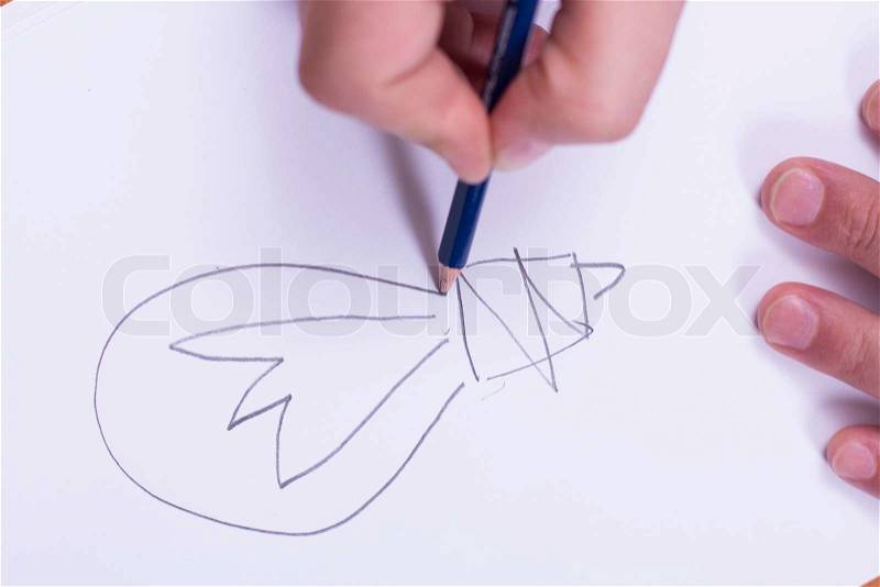 Businessman draws a pencil on paper, stock photo