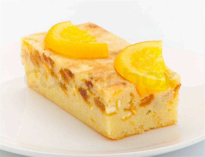 Orange cake melted with pieces of orange and topping on it for decorate, stock photo