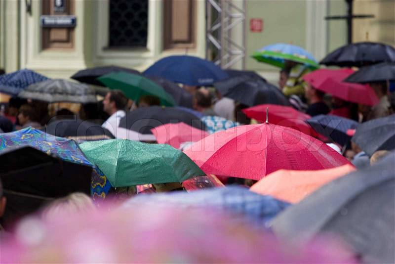 Crowd of people with umbrellas, stock photo