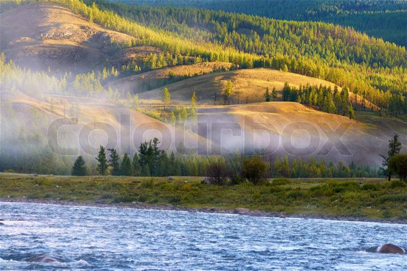 Morning fog on river Shishged in northern Mongolia, stock photo