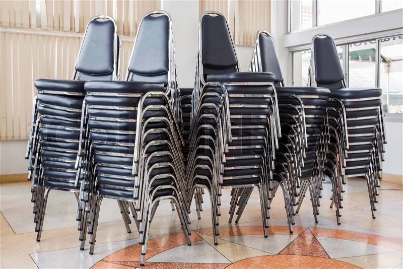 Stack of chairs in meeting room, stock photo