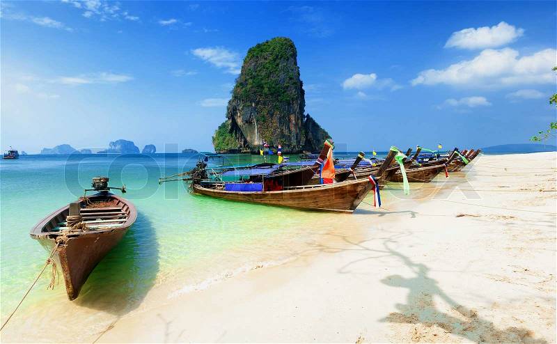 Thailand beach. Beautiful tropical landscape with boat, blue and clear ocean water, white sand and island. Thai journey photography, stock photo