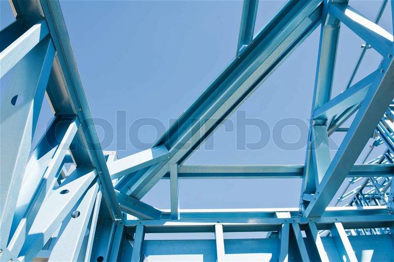 New residential construction home framing against a blue sky, stock photo