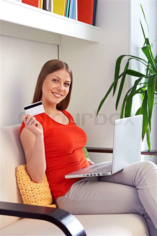 Woman shopping with laptop and credit card, stock photo