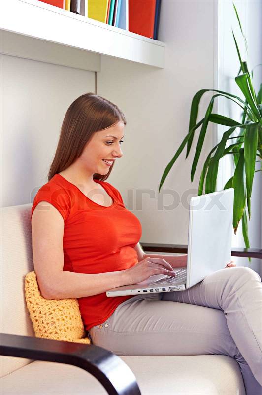 Young woman working with pc at home, stock photo