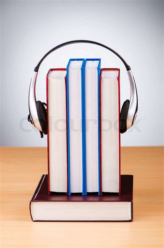 Concept of audio books with earphones on white, stock photo
