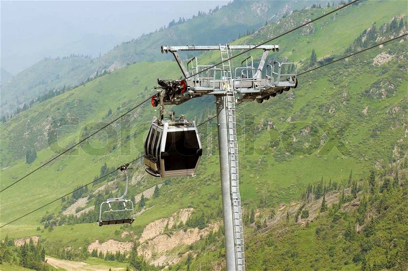 Cable car through Alps mountains in the summer, stock photo
