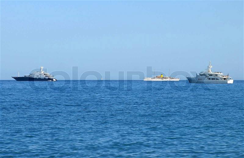 Luxury yachts and old passenger ship in Saint-Tropez, French Riviera, stock photo