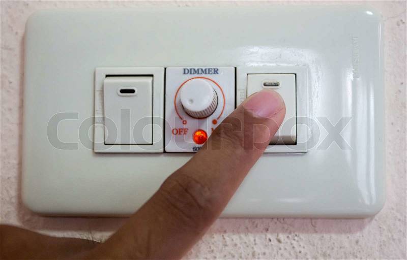 Turning off or turning on the switch light and dimmer, stock photo