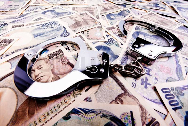 Yen bills, currency from japan with handcuffs, stock photo