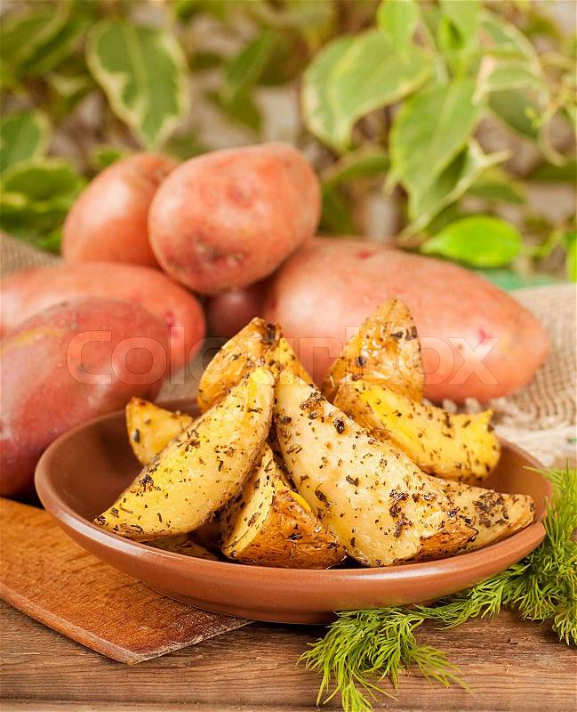 Potatoes baked in an oven with spices and, stock photo