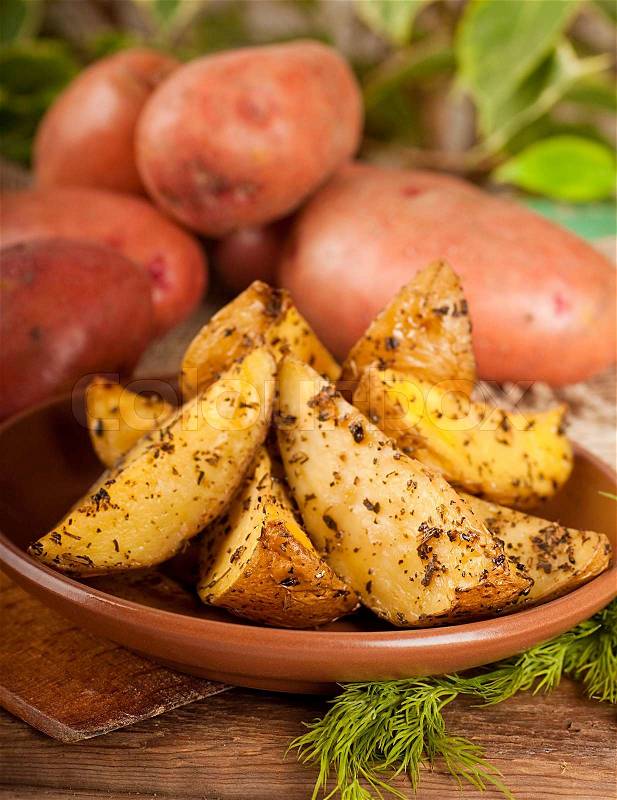 Potatoes baked in an oven with spices and, stock photo