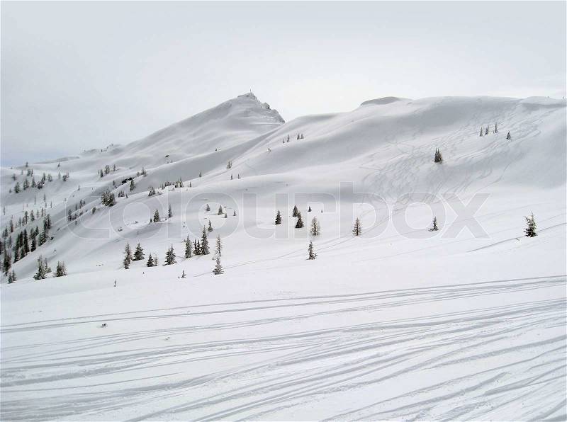 Winter sports scenery in Wagrain Austria with ski slope in hilly ambiance with lots of snow, stock photo