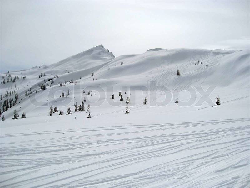 Winter scenery in Wagrain Austria with ski slope and lots of snow in hilly ambiance, stock photo