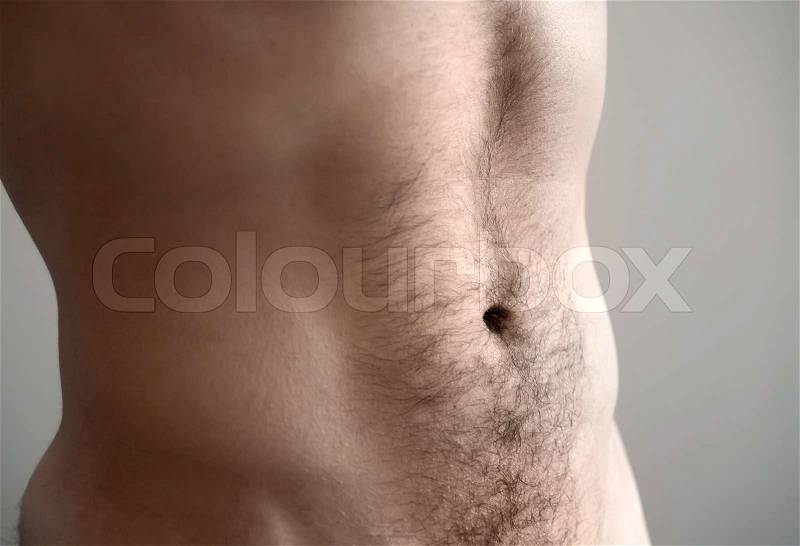 Flat man's belly. Closeup photo with shallow depth of field, stock photo