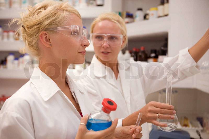Students working chemistry laboratory, stock photo