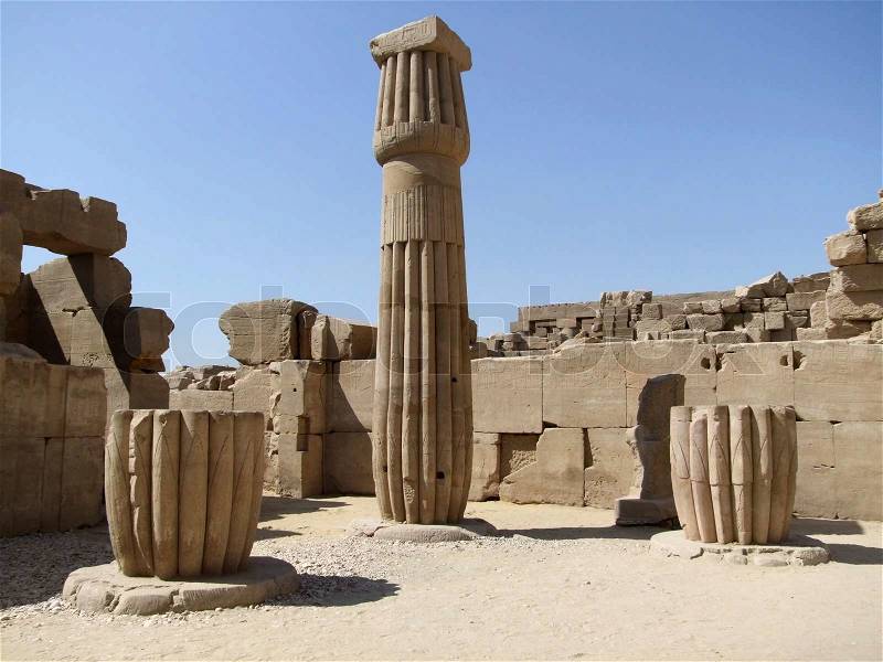 Scenery around Precinct of Amun-Re in Egypt with decorative column and various stone remains in sunny ambiance, stock photo