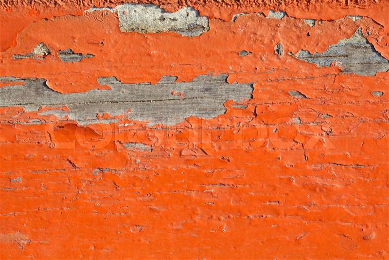 Close up shot of old orange paint texture peeling off wood plank background, stock photo