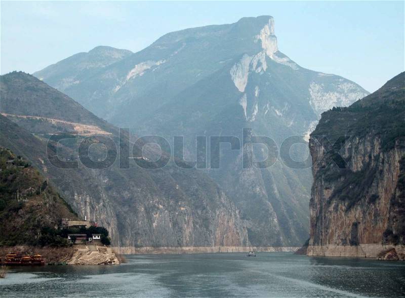 Waterside scenery along the Yangtze River in China including mountains and rock faces, stock photo