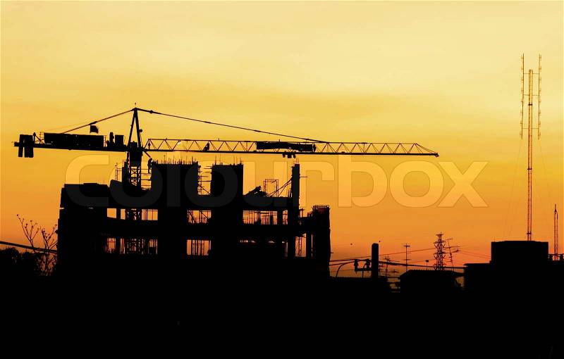 Industrial building construction cranes silhouettes, stock photo