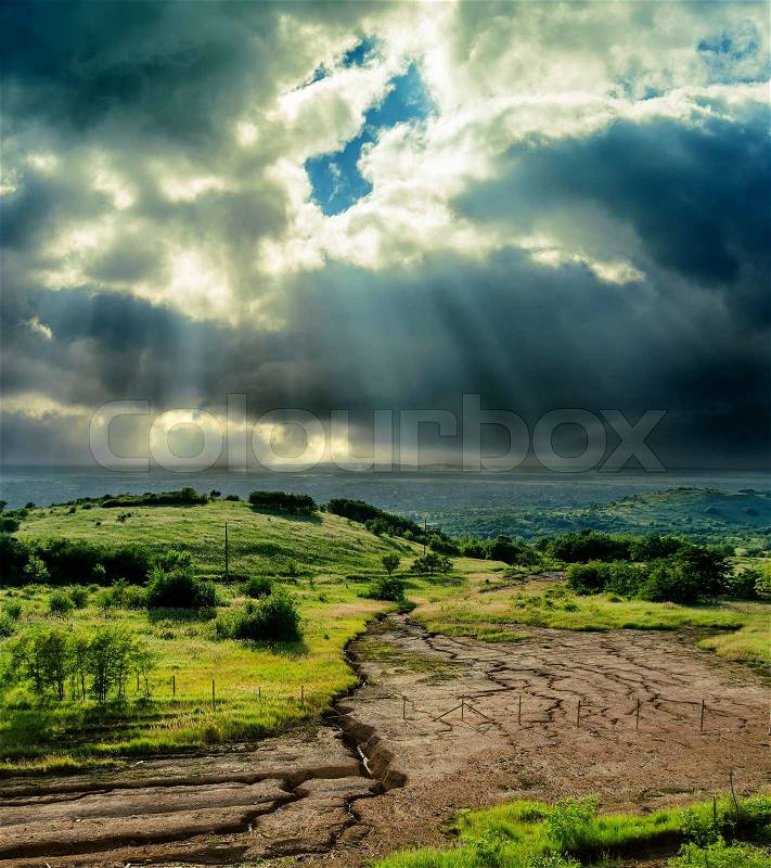 Dramatic sky over drought earth, stock photo