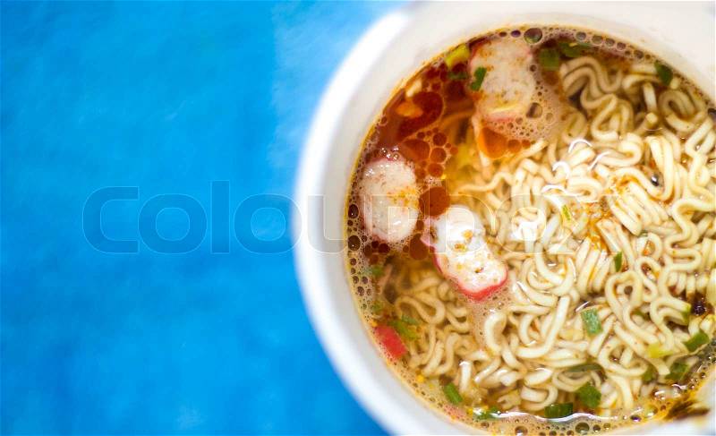 Instant noodle on background blue, stock photo