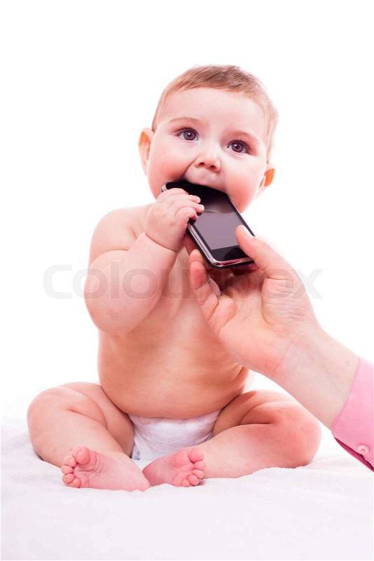 Development of the baby plays with mobile phone, stock photo