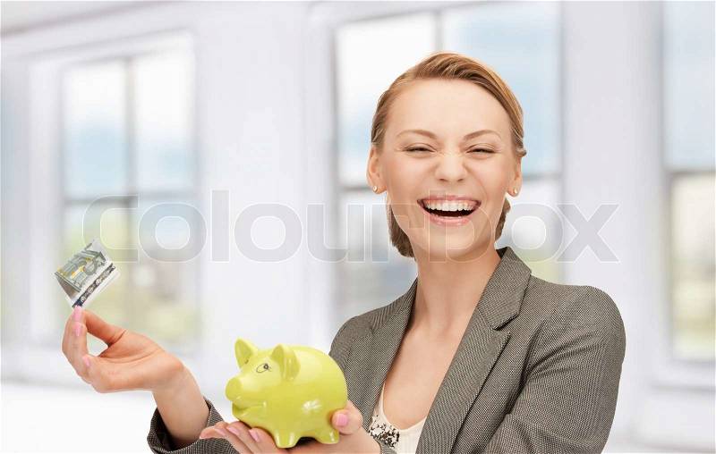 Picture of lovely woman with piggy bank and money, stock photo