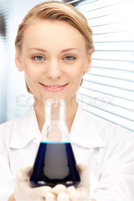 Picture of beautiful lab worker holding up test tube, stock photo