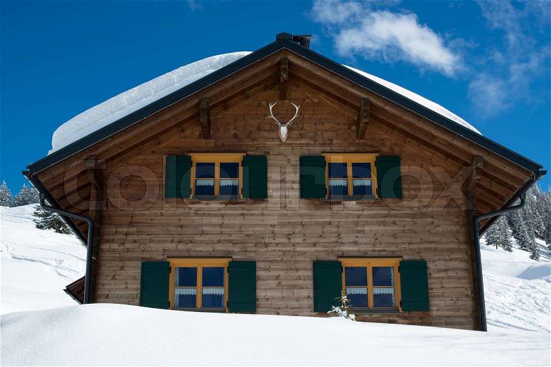 Beautiful skiing hut in a valley of Montafon, photo taken from public skiing piste, stock photo