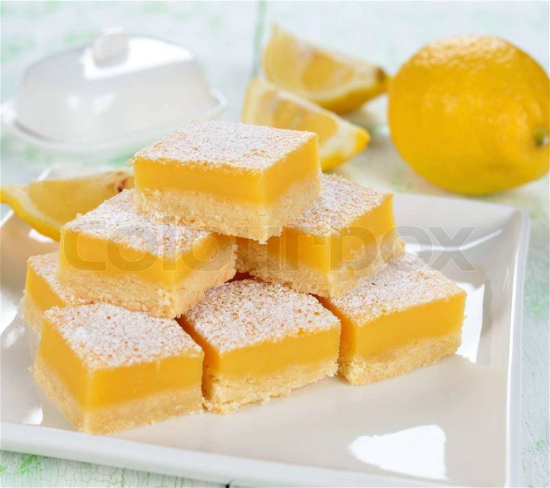 Traditional lemon bars on a white table, stock photo