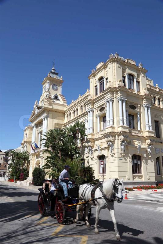 Horse-drawn carriage with tourists in front of the city hall of Malaga, Andalusia Spain, stock photo